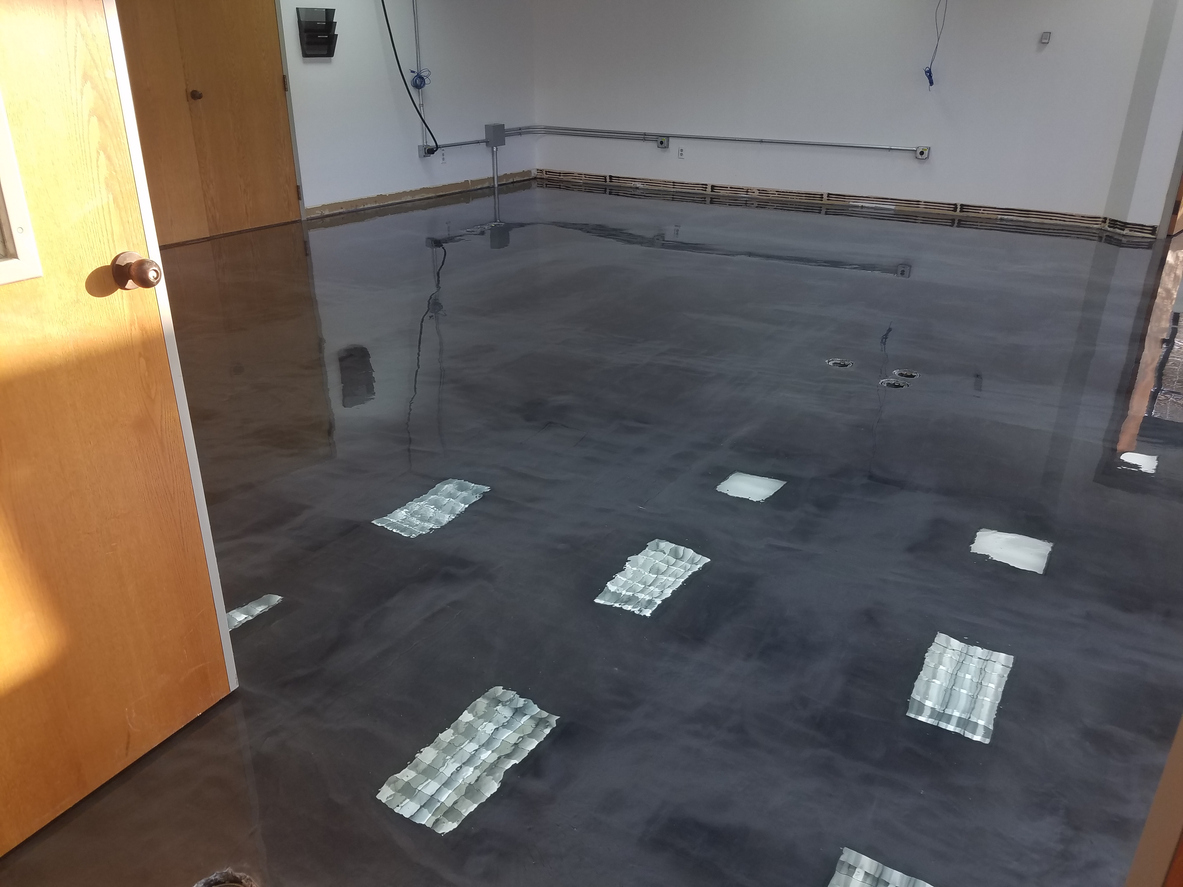Modern basement with a light metallic epoxy floor