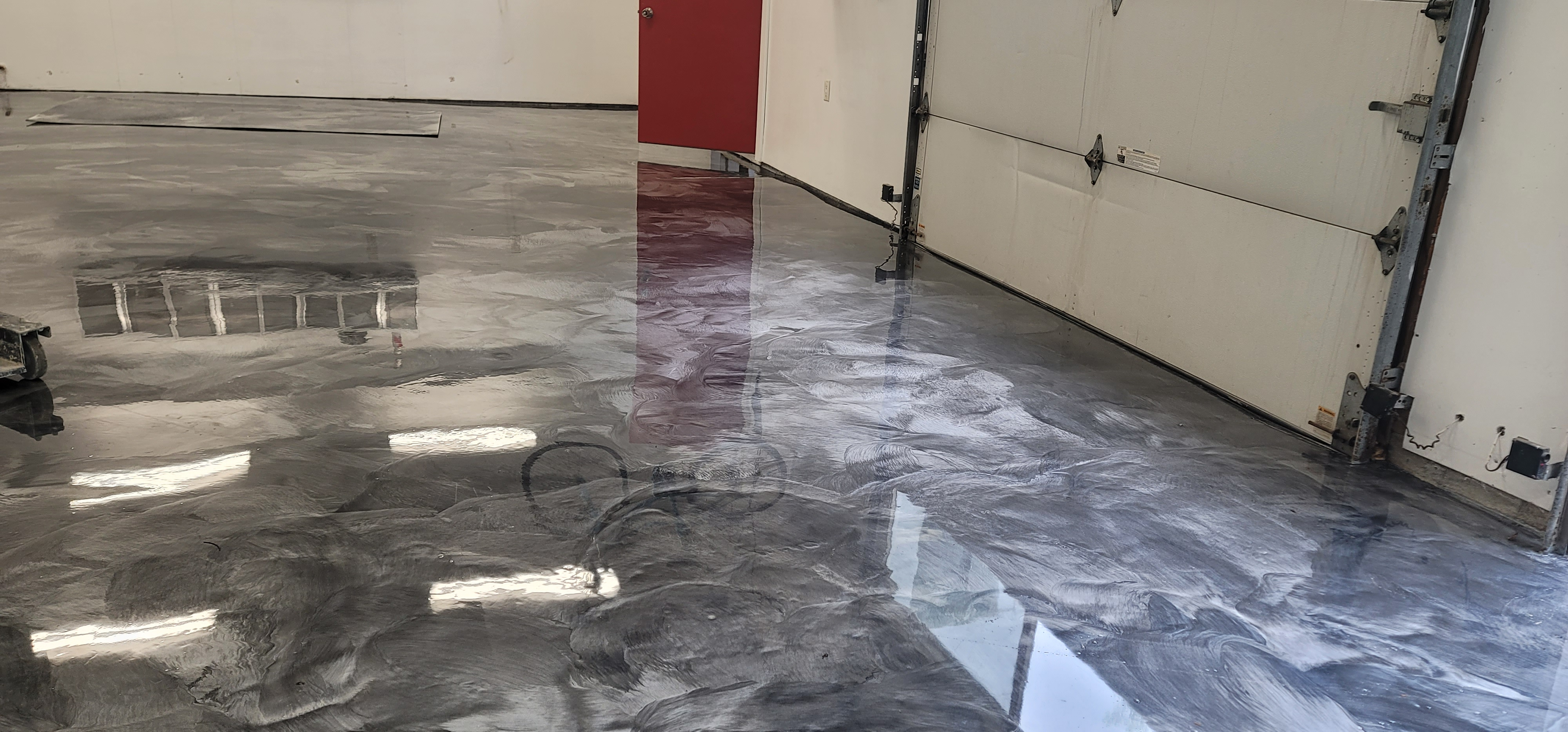 Metallic epoxy flooring in a Pasco Washington garage with a luxury car
